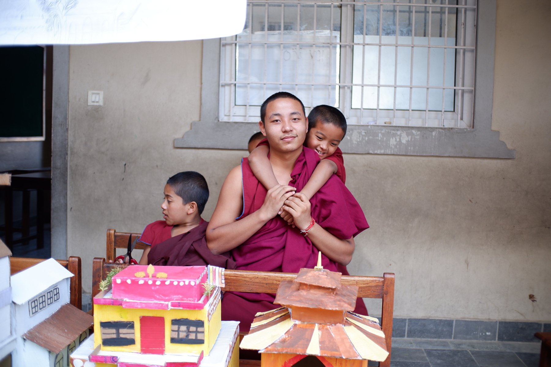 a monk is holding a child in their arms