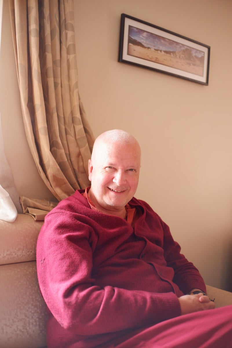 A protrait of a smiling Tibetan Buddhist Monk