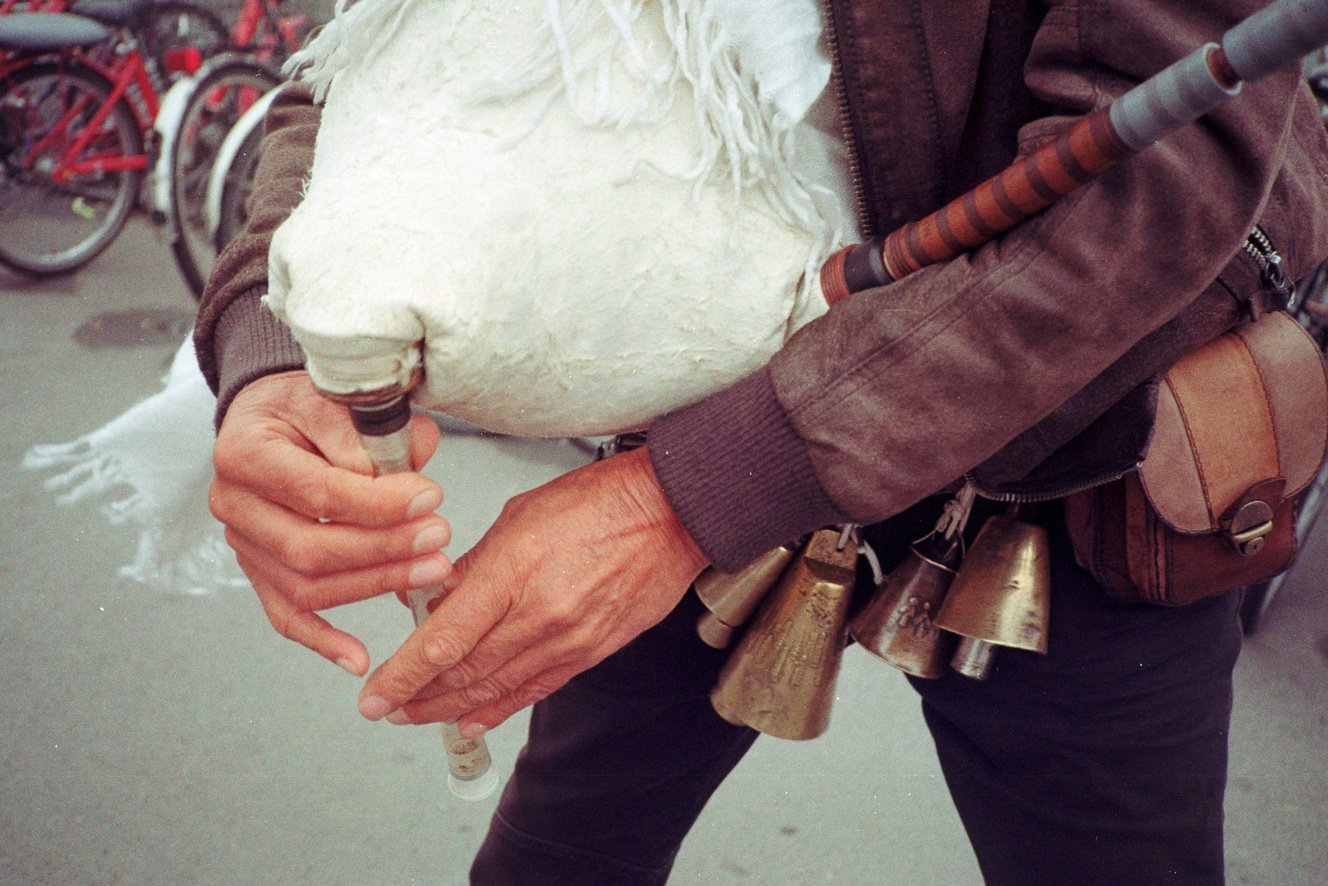 A street performer holding bagpipes.