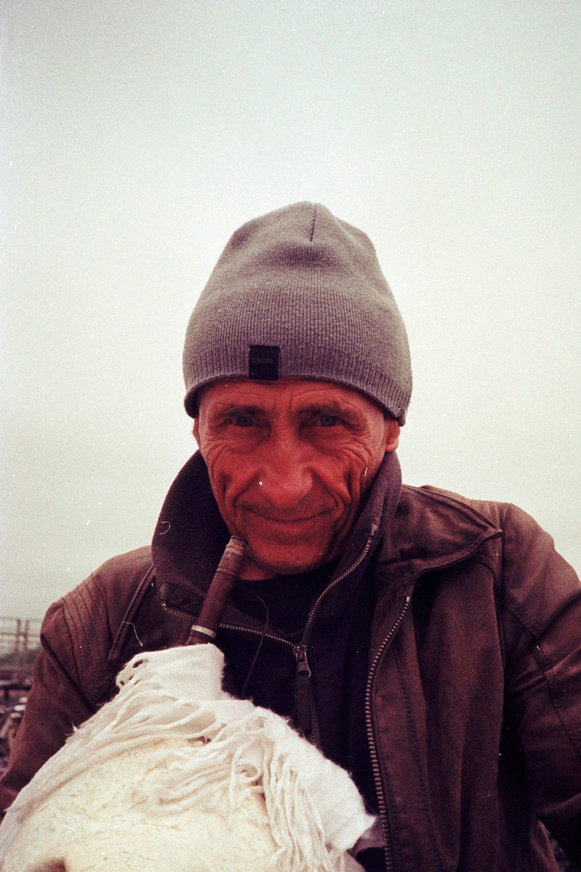 Candid portrait of street performer playing bagpipes.